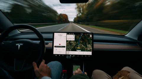 Foto del interior de la cabina de un modelo de Tesla con dos ocupantes