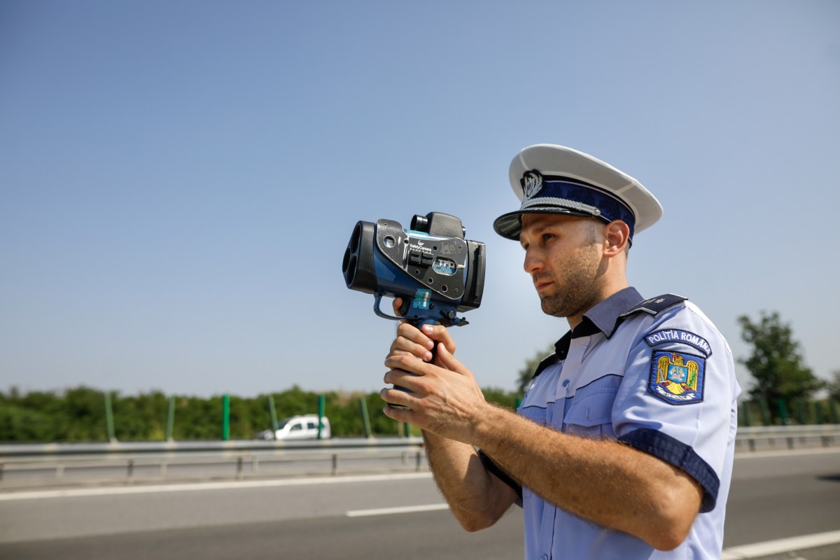 Policía con pistola de radar mide limite de velocidades