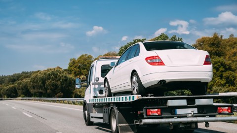 Foto de una grúa llevando un automóvil