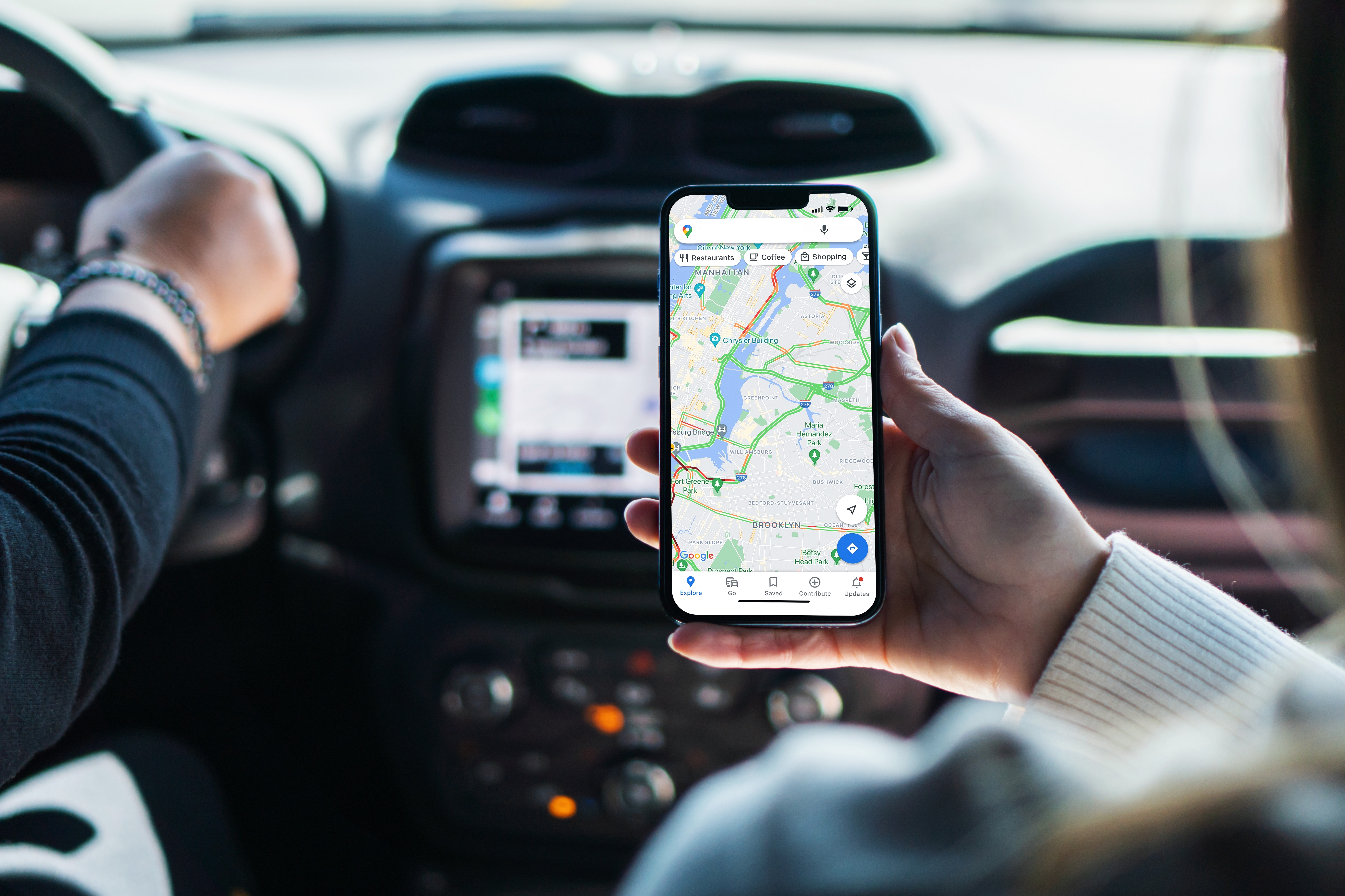 Girl,Inside,Car,Holding,Smartphone,With,Google,Maps,App,On