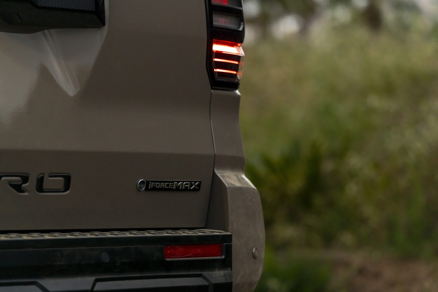 Vista trasera de una SUV Toyota TRD Pro en un entorno natural, con luz trasera encendida.