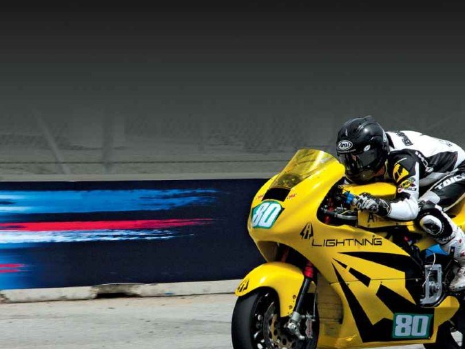 Lightning LS-218 amarilla en pista de carreras, 293 millas de autonomía eléctrica de alto rendimiento