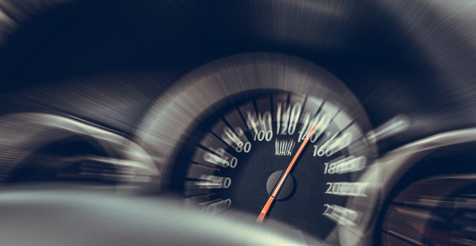 Velocímetro de auto en movimiento, enfoque en velocidad
