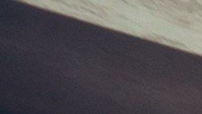 Una pareja joven se da la mano con un agente de ventas después de una exitosa compra de camiones.