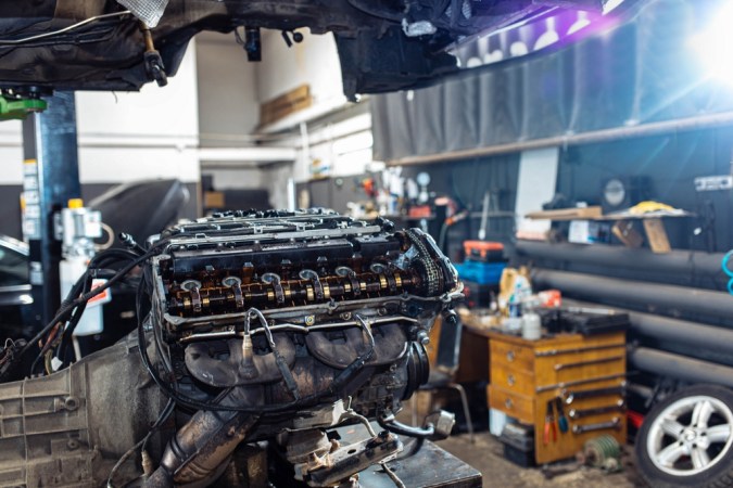 Motor en taller con culata expuesta, útil para reparar humo del tapón de aceite y mantenimiento automotriz.