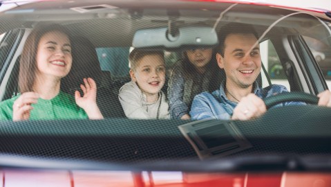 The family chooses a car at the car dealership. Focus on kids