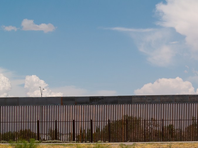Border Patrol and El Paso Texas police guard the body of a man who was found dead inside the Rio Grande.