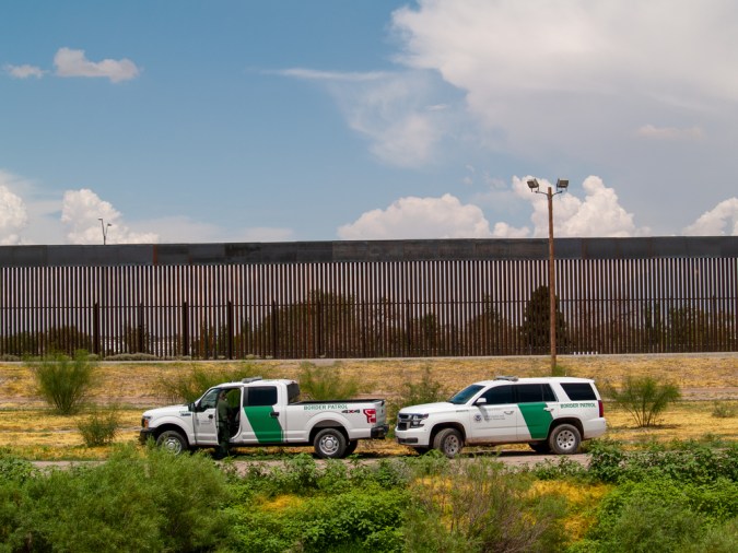 Border Patrol and El Paso Texas police guard the body of a man who was found dead inside the Rio Grande.
