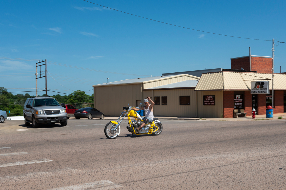 Un motociclista montando un helicóptero amarillo por la Ruta 66 de los Estados Unidos, en el estado de Oklahoma.