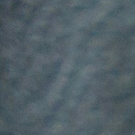 Una persona con guantes de punto azul enciende el calentador del asiento en un automóvil