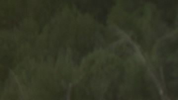 Toyota Corolla Cross XLE AWD 2026 rojo cristal perfil lateral en paisaje árido, crossover Toyota 2026 importación legal.