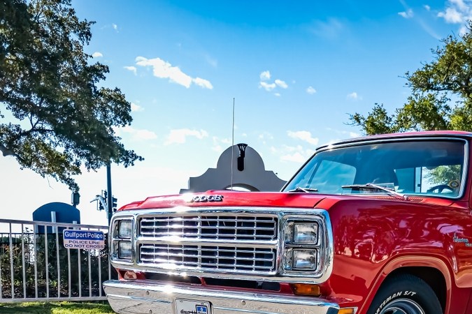 Vista de esquina frontal de baja perspectiva de un Dodge Adventurer 150 Li'l Red Express Truck de 1979 en una feria local de automóviles.