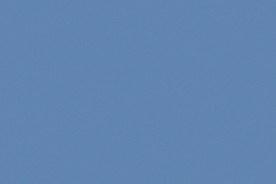 Hyundai Palisade híbrido 2026 en movimiento por autopista soleada, diseño robusto y eficiente.