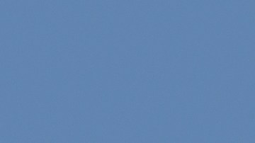 Hyundai Palisade híbrido 2026 en movimiento por autopista soleada, diseño robusto y eficiente.