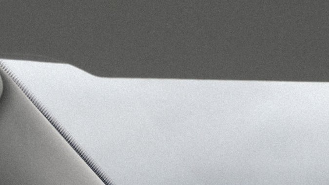 Interior Rivian R2 2027 con pantallas y volante avanzado, cabina premium SUV eléctrico compacto.