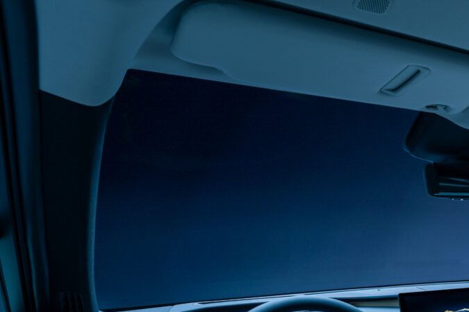 Interior Lexus TZ 2027 con pantalla central, volante digital, asientos claros e iluminación ambiental.