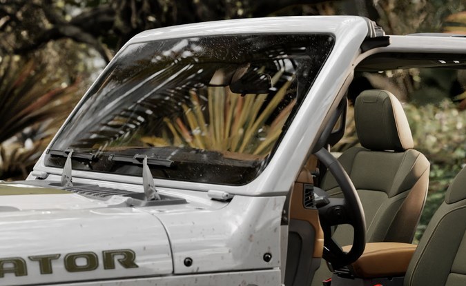 Jeep Gladiator blanca con las puertas retiradas, mostrando los asientos delanteros y traseros en un entorno de selva.
