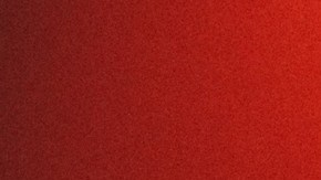 Escudo de Porsche en relieve sobre una superficie oscura iluminada con luz roja, imagen de adelanto del Mission S.